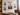 Gallery wall of clear acrylic floating picture frames with gold standoffs displayed in an office