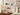 Gallery wall of clear acrylic floating picture frames with gold standoffs displayed in a bedroom