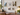 Gallery wall of clear acrylic floating picture frames with gold standoffs displayed in a home office