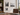 Gallery wall of clear acrylic floating picture frames with gold standoffs displayed in an office